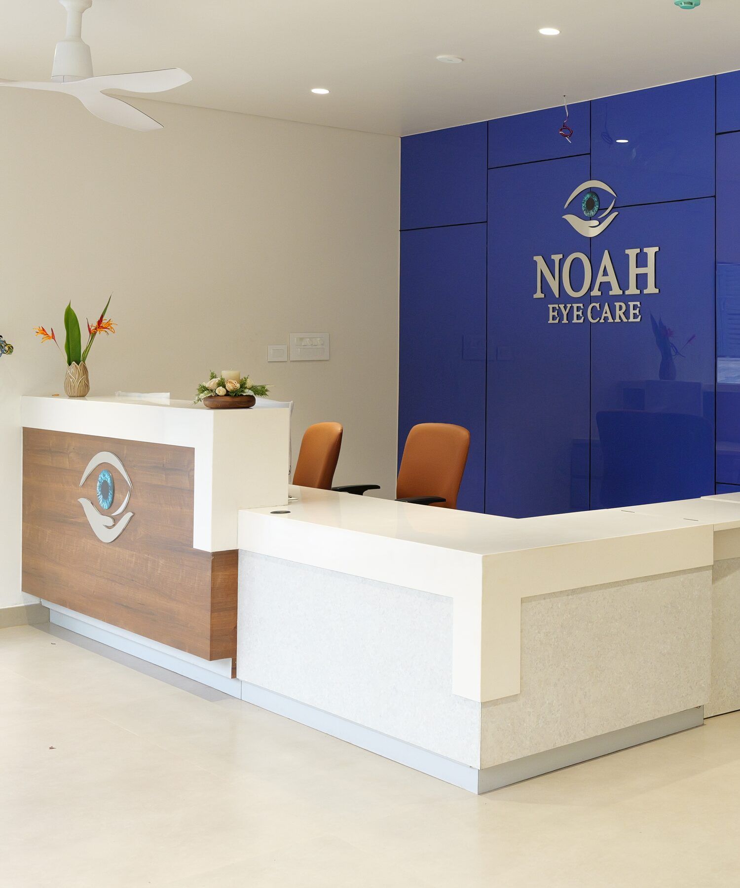 The reception at Noah Eye Care, with the clinic's name on a cobalt blue wall