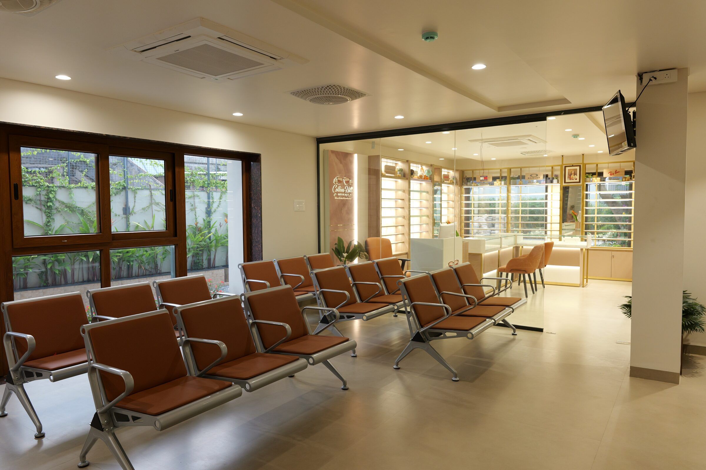A bright waiting hall with large windows onto greenery
